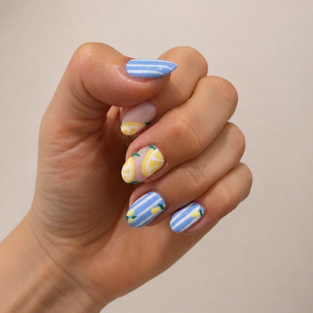 Blue and white striped nails with lemon nail art