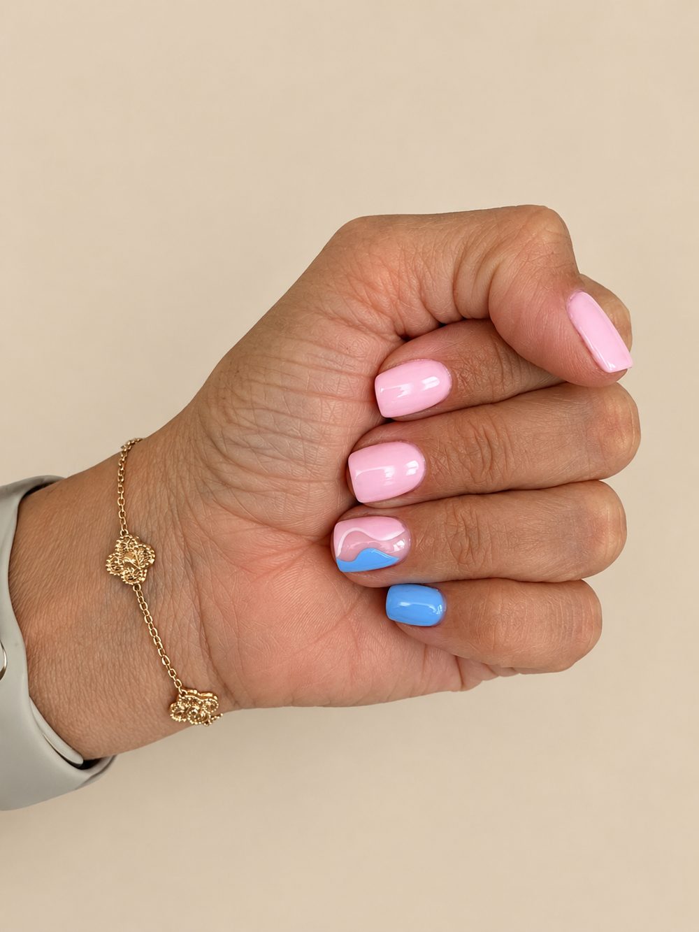 Pink and blue gel nails with a wave accent nail