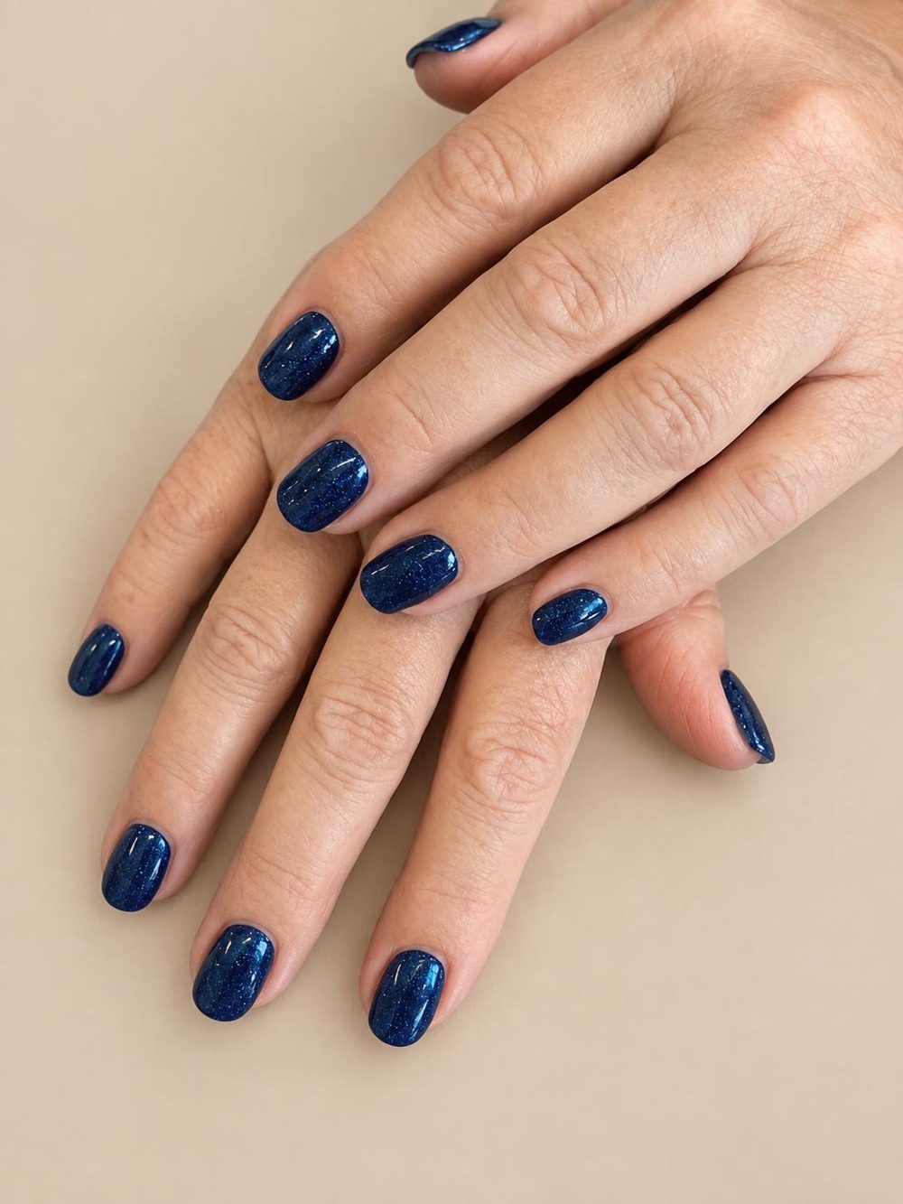 Midnight blue sparkle gel manicure